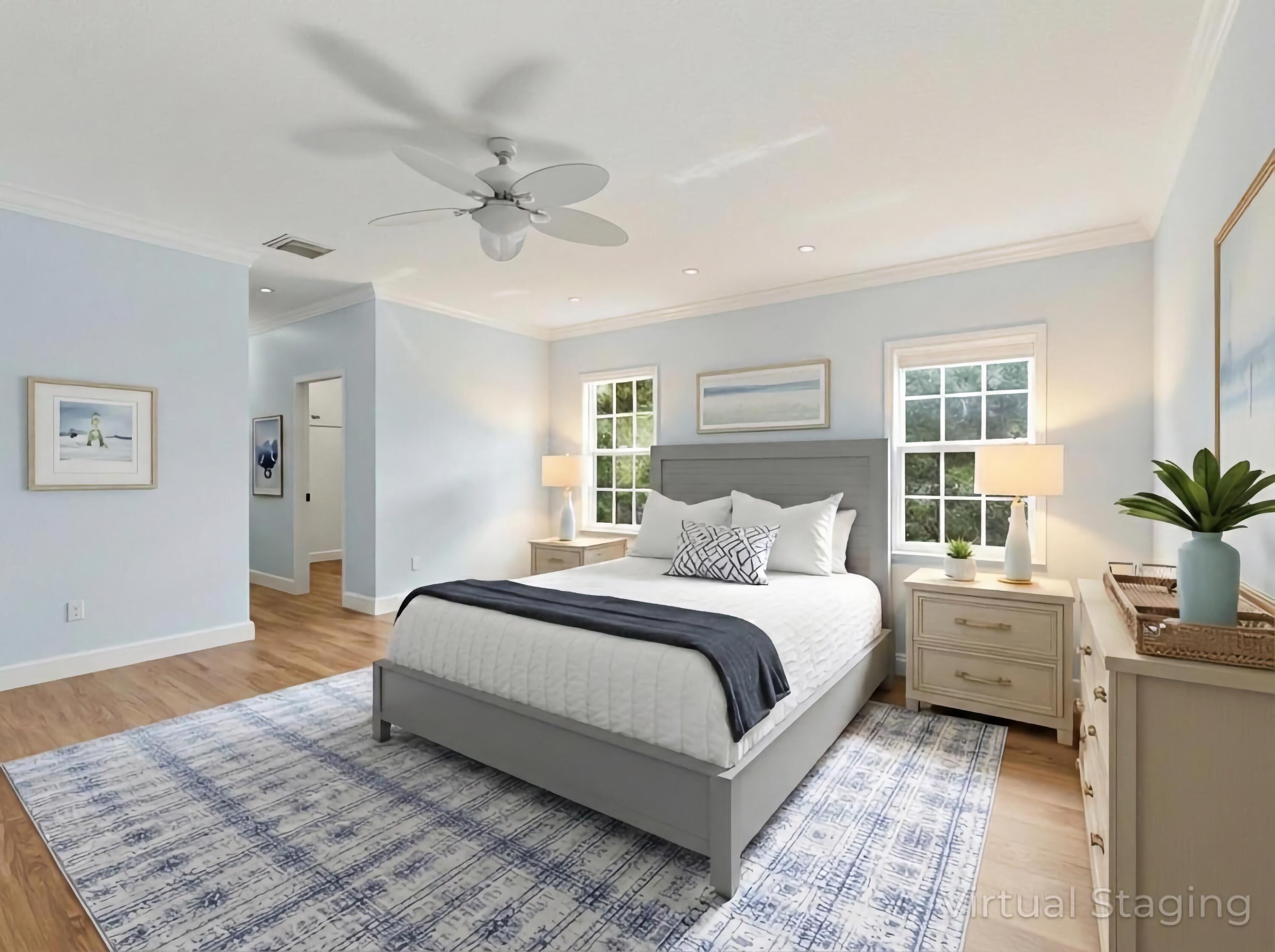 9322 Southeast Athena Street Hobe Sound, FL 33455 - Photo 32 of 68 a bedroom with a large bed and a chandelier