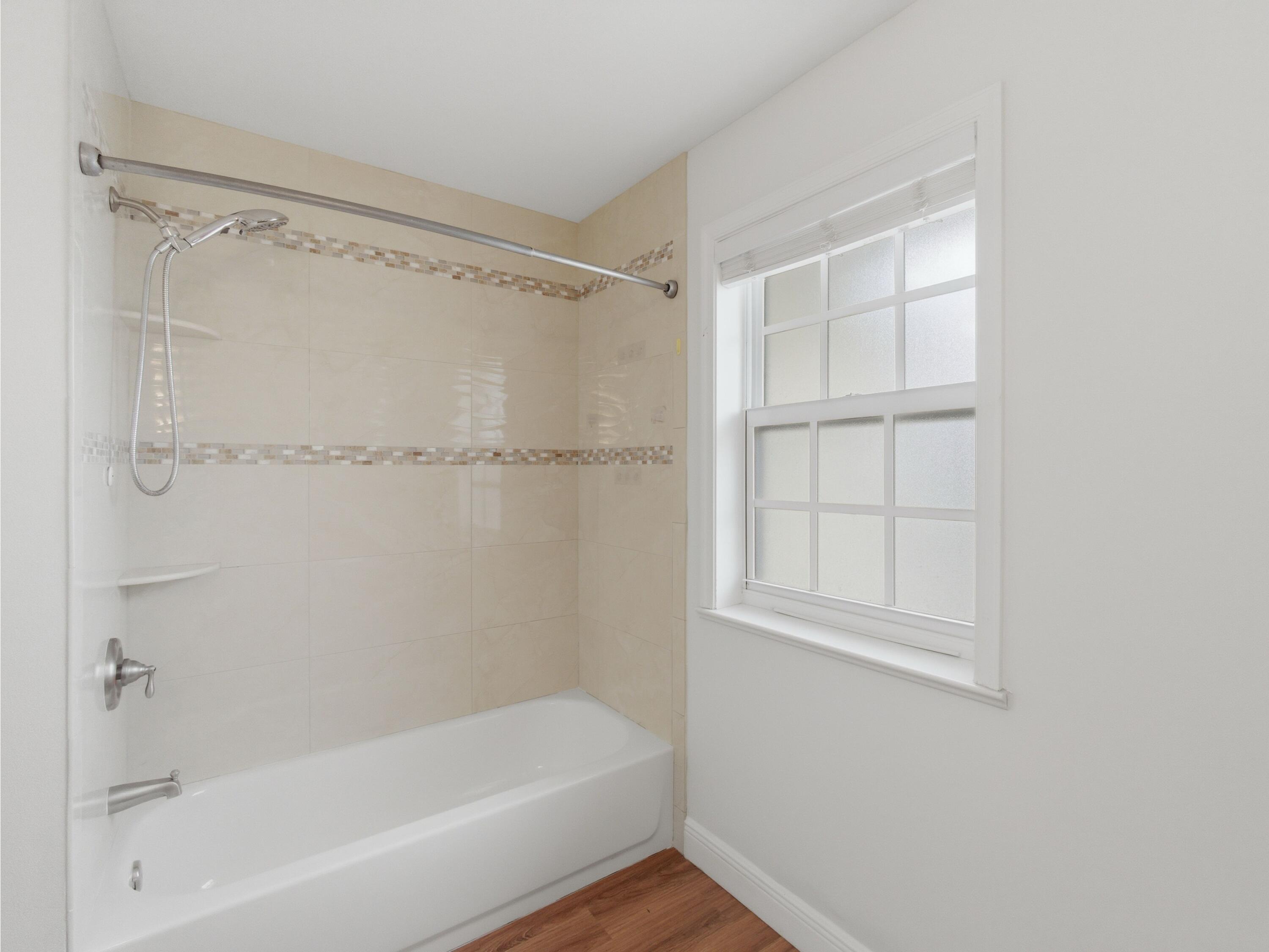 9322 Southeast Athena Street Hobe Sound, FL 33455 - Photo 50 of 68 a bathroom with a bathtub