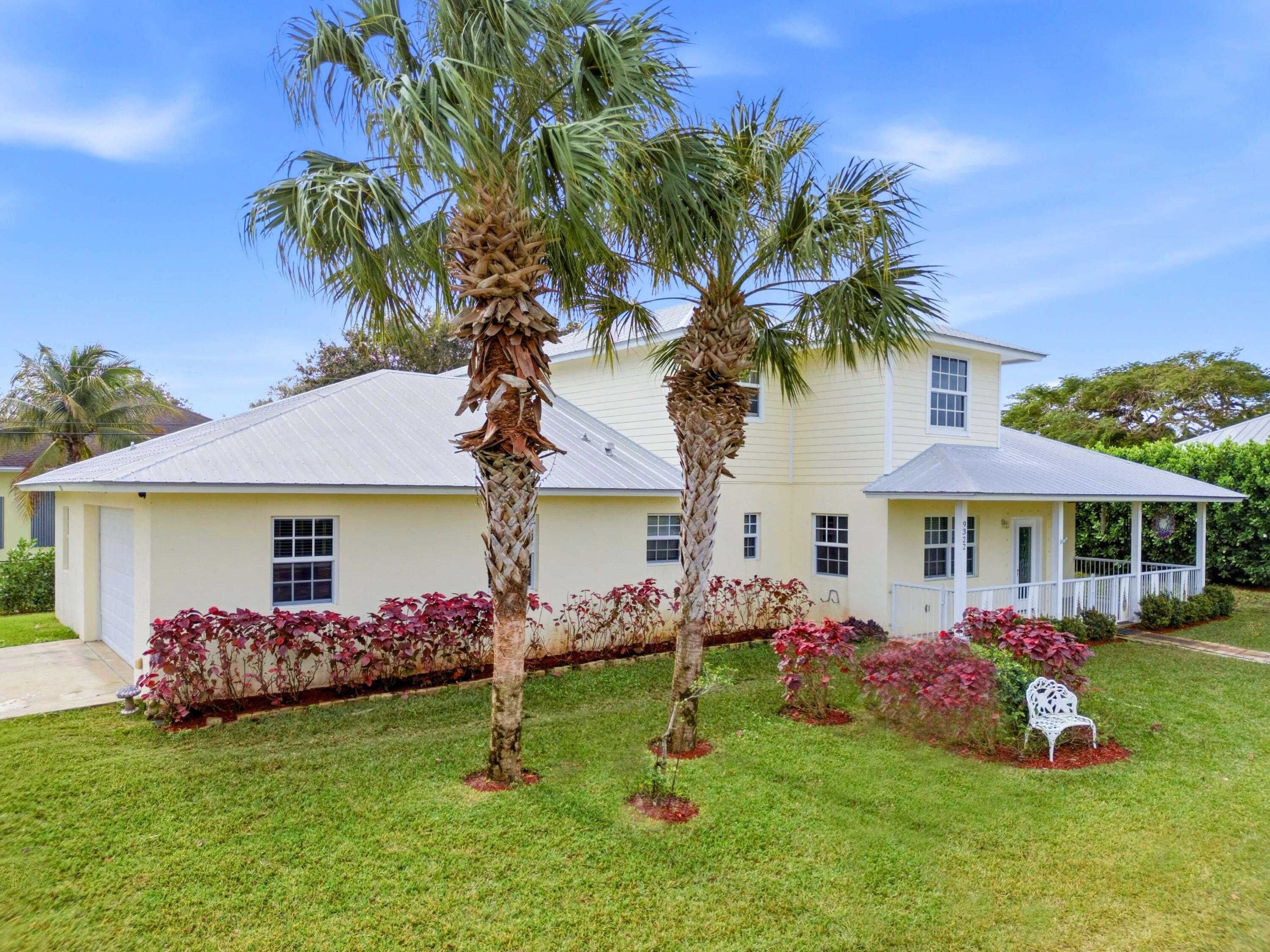 9322 Southeast Athena Street Hobe Sound, FL 33455 - Photo 65 of 68 a front view of house with yard and outdoor seating