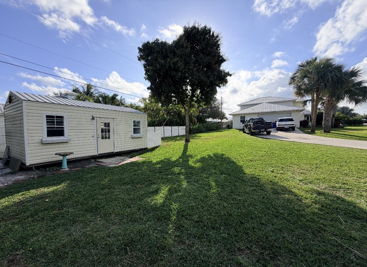 9322 Southeast Athena Street Hobe Sound, FL 33455 - Photo 68 of 68 a view of a house with a backyard