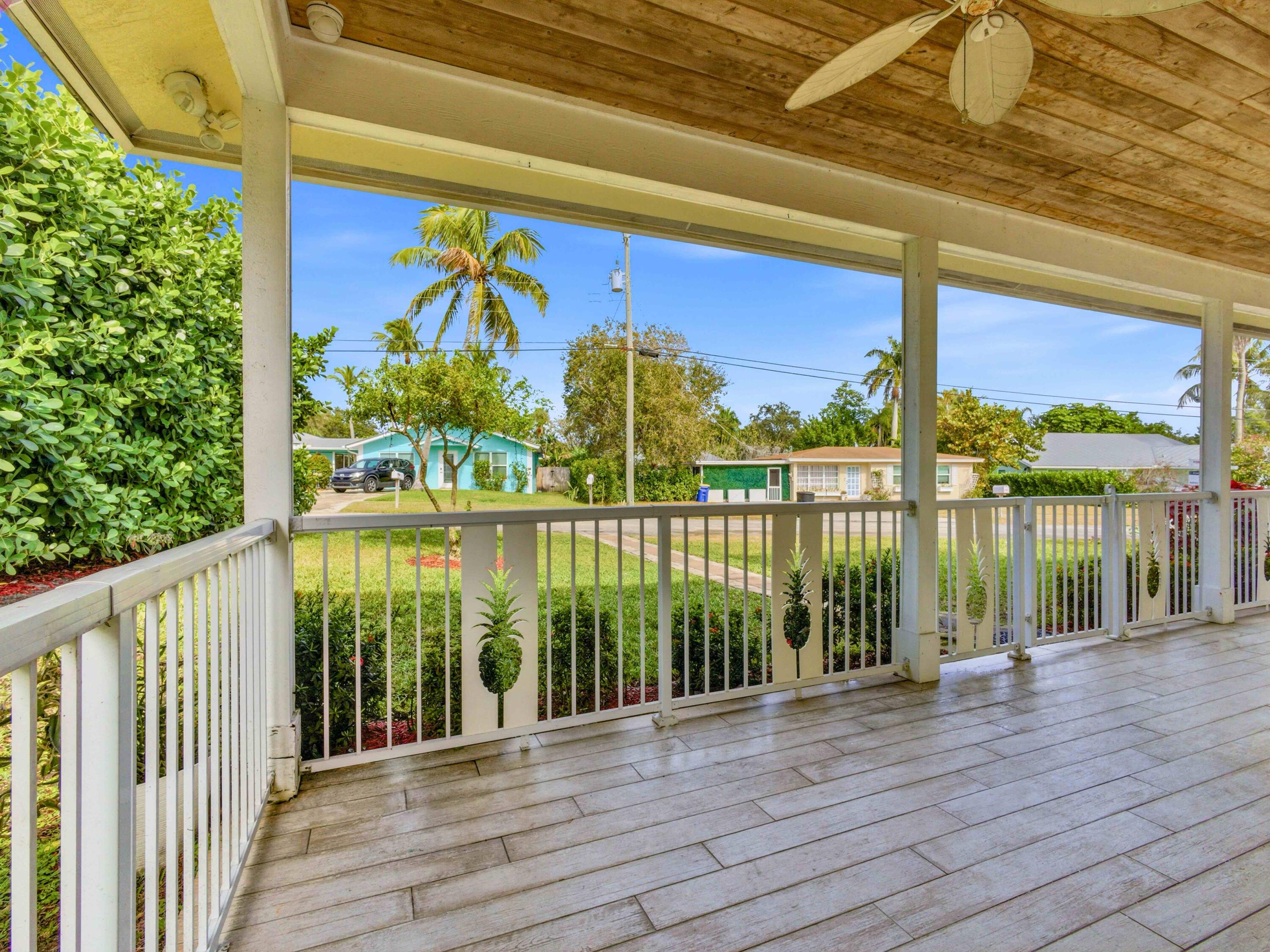 9322 Southeast Athena Street Hobe Sound, FL 33455 - Photo 7 of 68 a view of a balcony with wooden floor and outdoor space