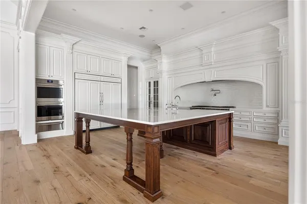 a living room with wooden floor and furniture