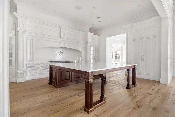 a kitchen with kitchen island a stove and a wooden floors