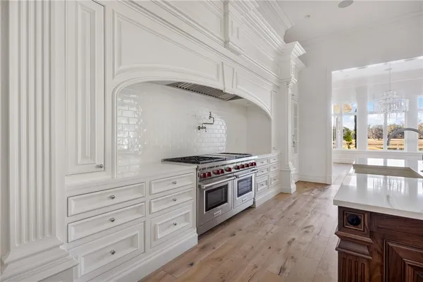 a kitchen with granite countertop white cabinets and white appliances