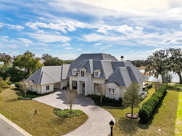 a aerial view of a house next to a big yard