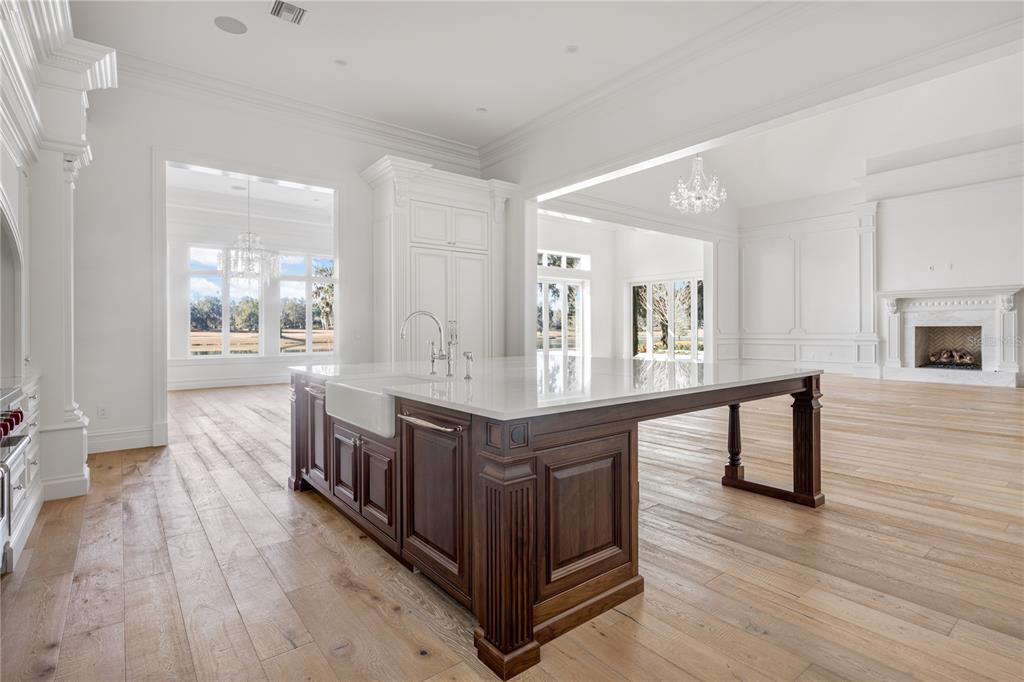 8570 Northwest 31st Lane Road Ocala, FL 34482 - Photo 21 of 53 a large white kitchen with sink and wooden floor