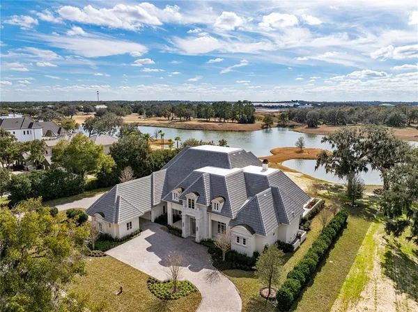 an aerial view of a house with a ocean view