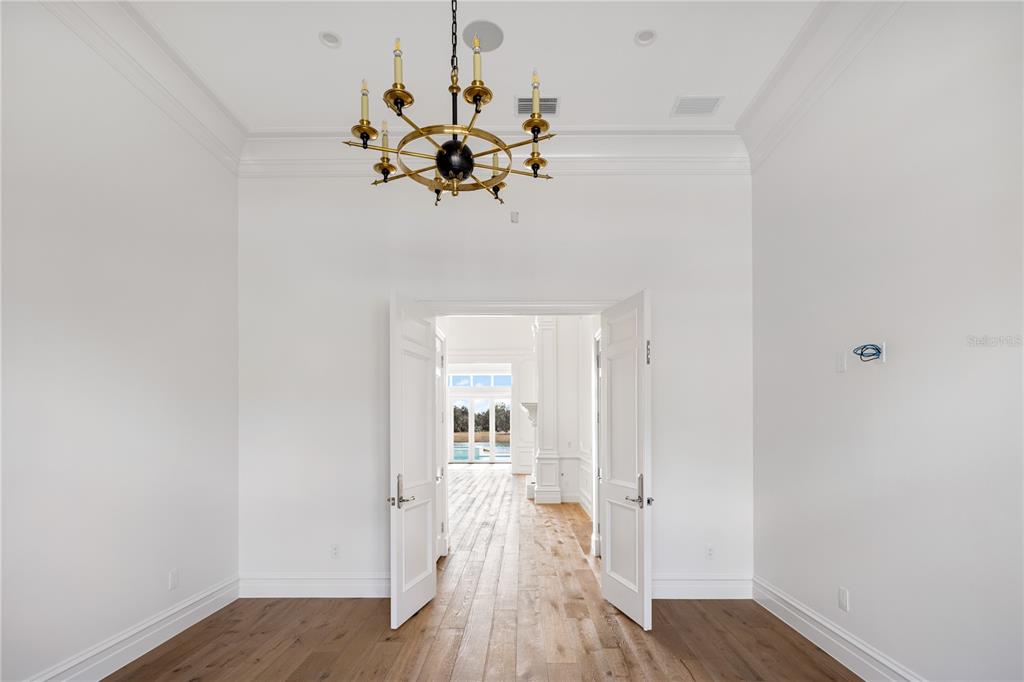 8570 Northwest 31st Lane Road Ocala, FL 34482 - Photo 32 of 53 a view of a room with wooden floor closet and a chandelier fan