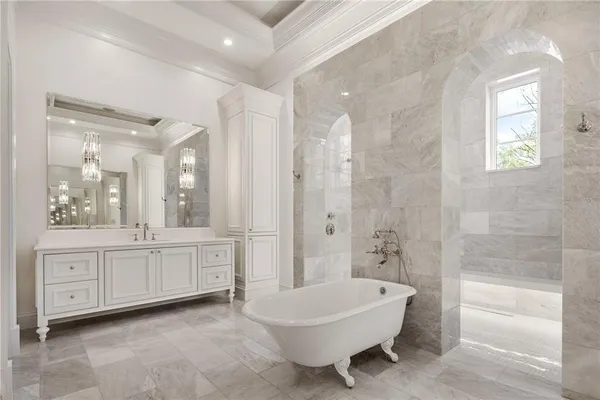 a spacious bathroom with a granite countertop sink a toilet a mirror and bathtub