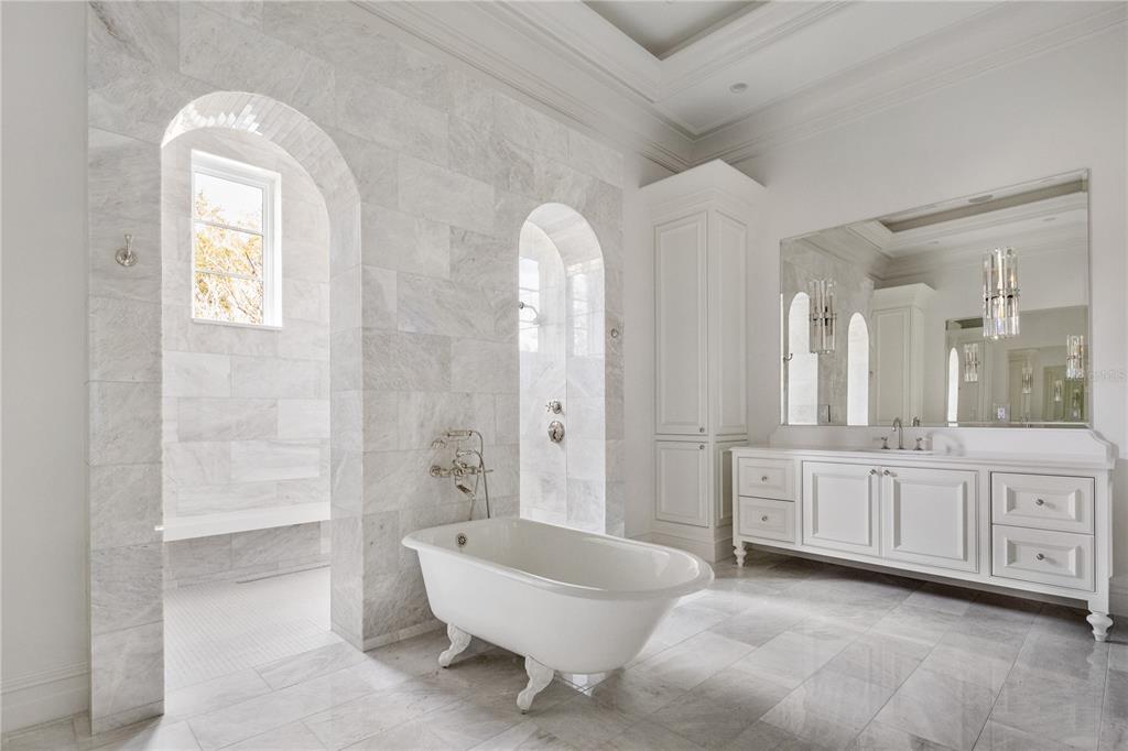 8570 Northwest 31st Lane Road Ocala, FL 34482 - Photo 38 of 53 a spacious bathroom with a granite countertop sink a toilet a mirror and bathtub