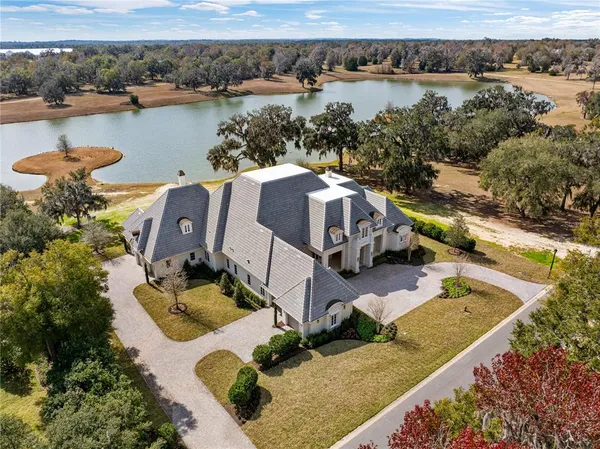 an aerial view of a house with lake view