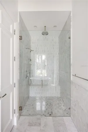 a bathroom with a double vanity sink a toilet and a shower