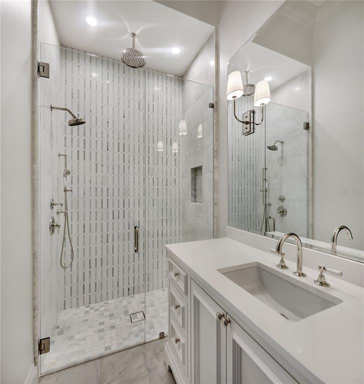 8570 Northwest 31st Lane Road Ocala, FL 34482 - Photo 53 of 53 a bathroom with a shower sink vanity and mirror