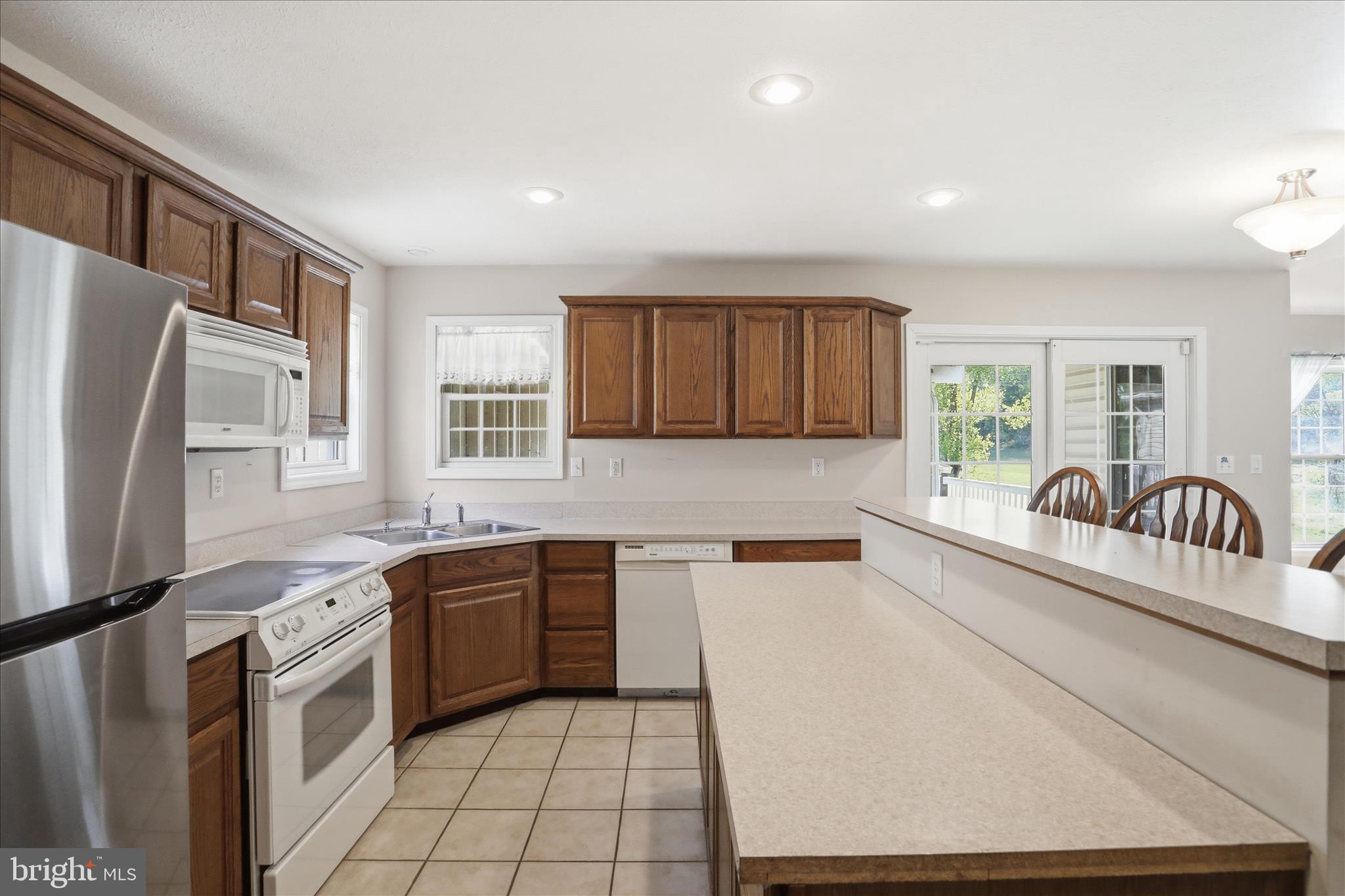 13605 McKenzie Tower Road Southwest Cumberland, MD 21502 - Photo 14 of 63 a kitchen with granite countertop a sink stainless steel appliances and cabinets