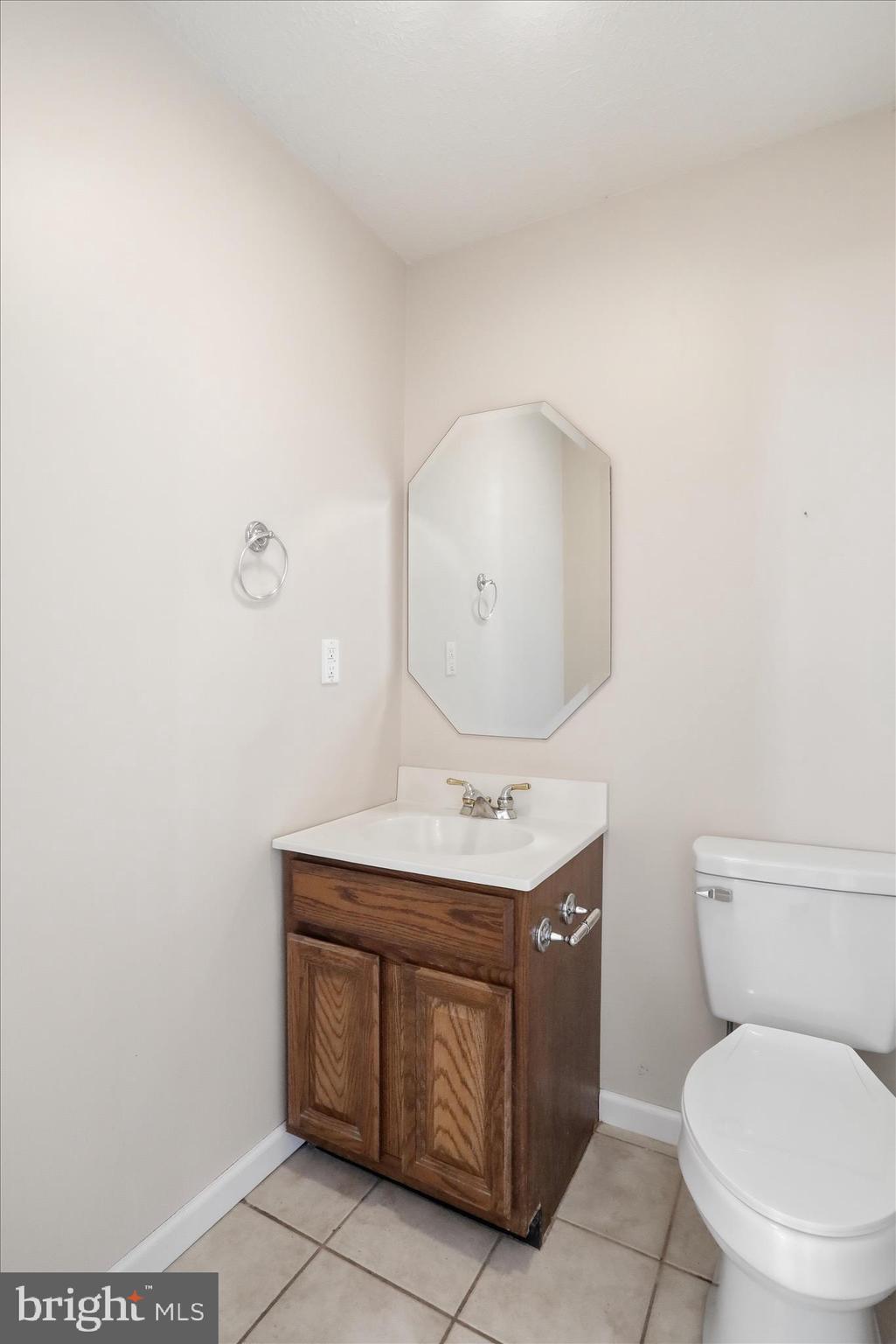 13605 McKenzie Tower Road Southwest Cumberland, MD 21502 - Photo 21 of 63 a bathroom with a granite countertop toilet sink and mirror