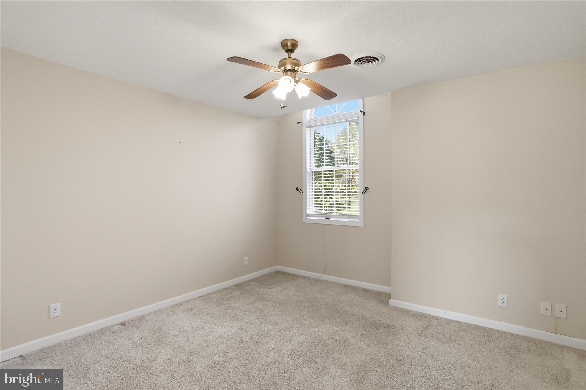 13605 McKenzie Tower Road Southwest Cumberland, MD 21502 - Photo 28 of 63 an empty room with a window and a fan