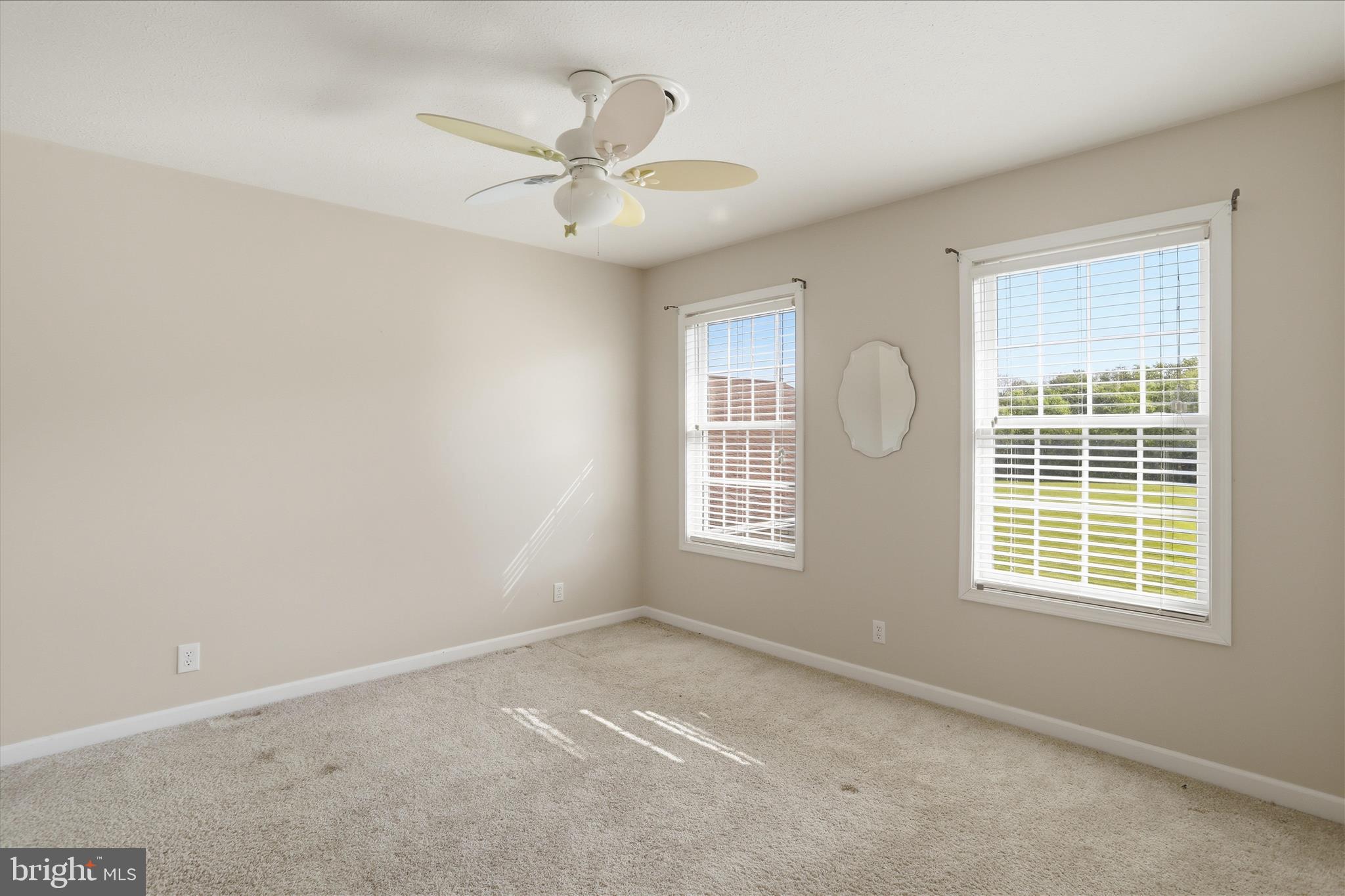 13605 McKenzie Tower Road Southwest Cumberland, MD 21502 - Photo 33 of 63 an empty room with windows and fan