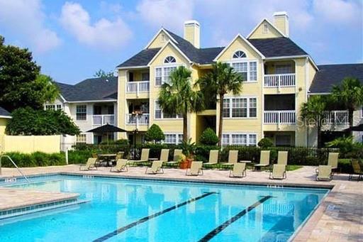 1023 South Hiawassee Road, Unit 4013 Orlando, FL 32835 - Photo 2 of 10 a front view of a house with swimming pool having outdoor seating