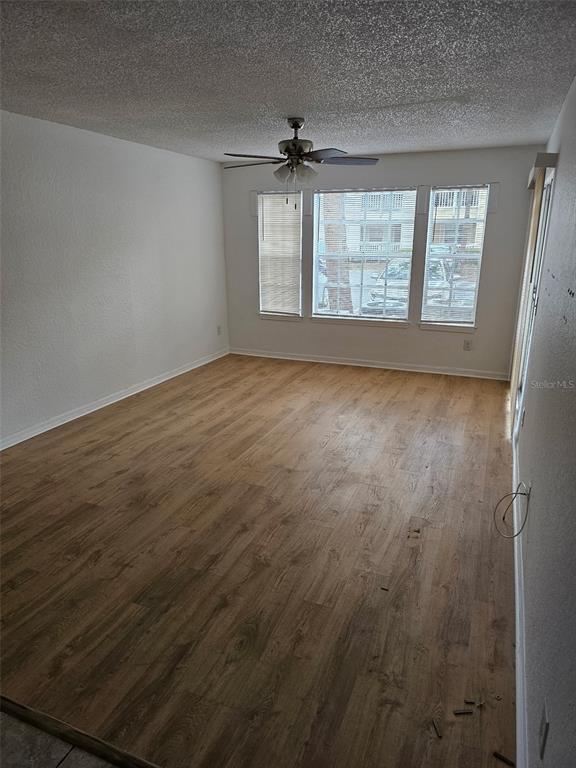 1023 South Hiawassee Road, Unit 4013 Orlando, FL 32835 - Photo 6 of 10 an empty room with wooden floor and windows