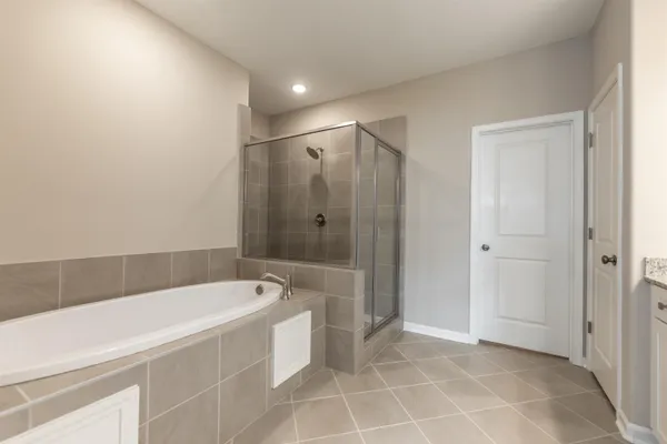 a spacious bathroom with a bathtub and a shower