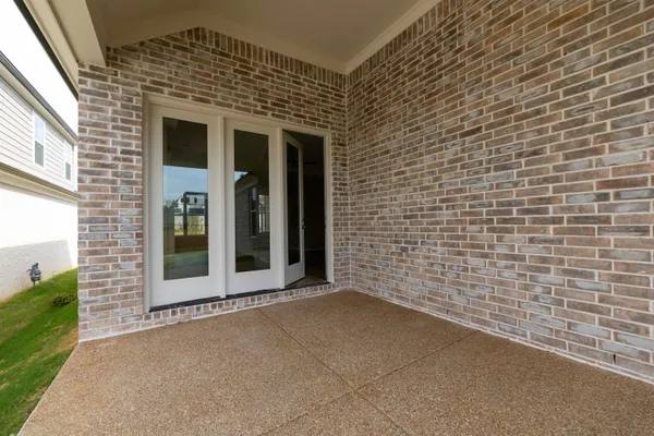 a view of a brick house with a large window