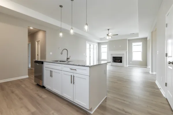 a spacious bathroom with a granite countertop sink a mirror and vanity
