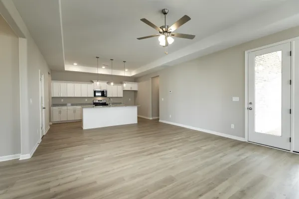 a view of a kitchen with a sink cabinets and wooden floor
