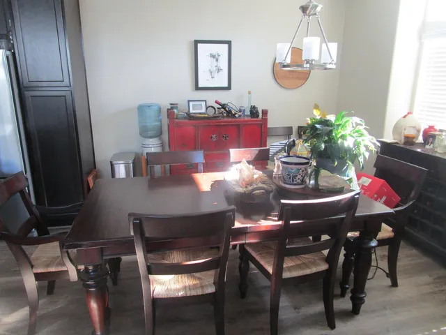 a view of a dining room with furniture and chandelier