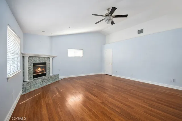 wooden floor in an empty room with a fireplace