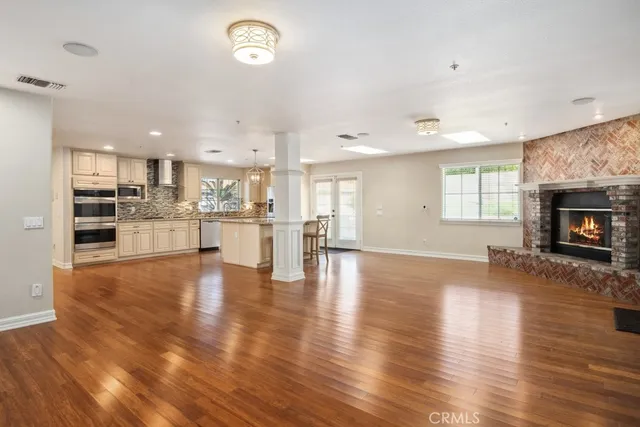 a view of kitchen and hall with wooden floor