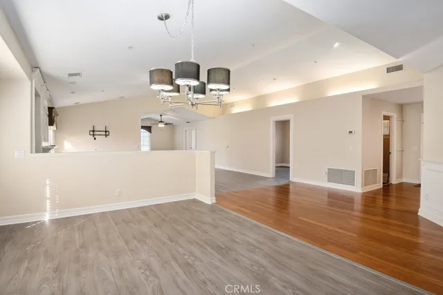 a view of a kitchen with a sink dishwasher cabinets and wooden floor