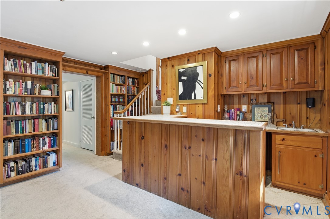 6405 Buckhill Road Richmond, VA 23225 - Photo 36 of 71 Wood-paneled room featuring a built-in bar with si