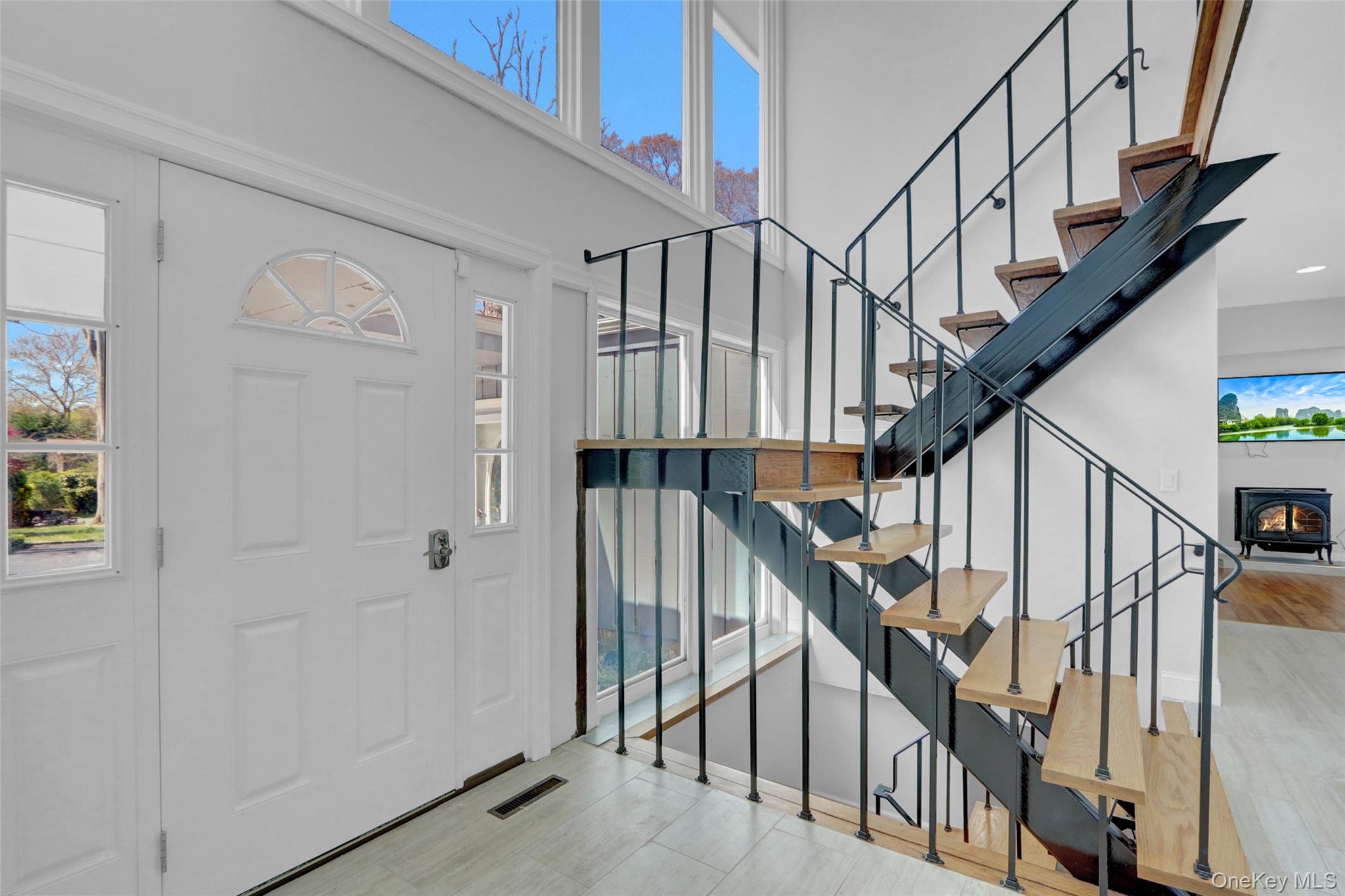 25 Wildwood Road Rocky Point, NY 11778 - Photo 11 of 47 Entrance foyer with stairway and a high ceiling