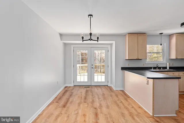 a view of a kitchen with sink a dishwasher and a large window