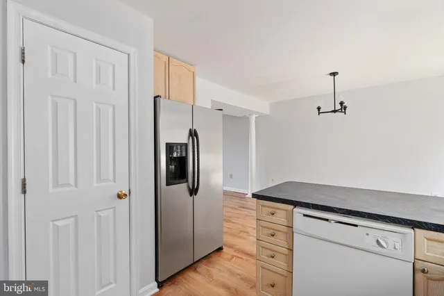 a kitchen with a refrigerator and countertop