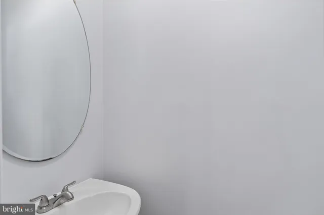 a bathroom with a sink and mirror