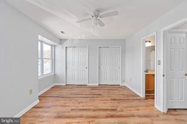 a view of a livingroom with a ceiling fan & window