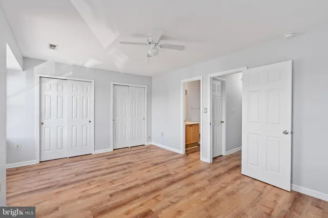 a view of empty room with wooden floor