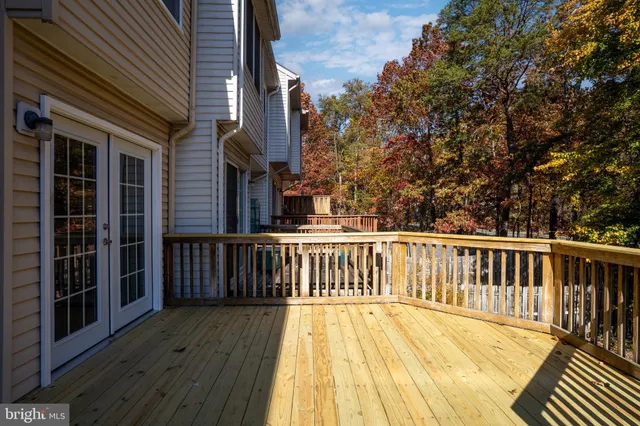a view of balcony with wooden floor and fence