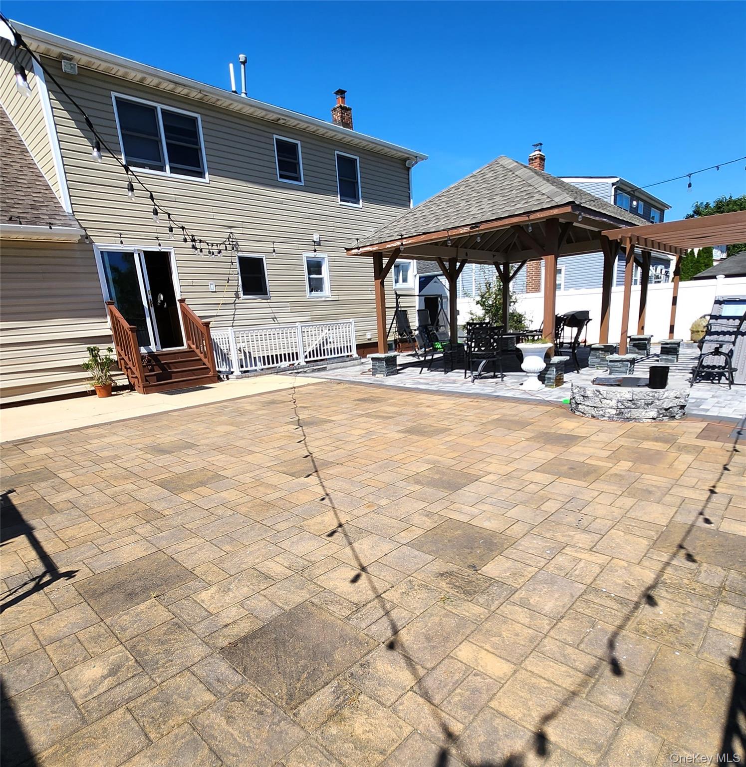 Undisclosed Address West Babylon, NY 11704 - Photo 2 of 12 a view of a white house with swimming pool in front of it