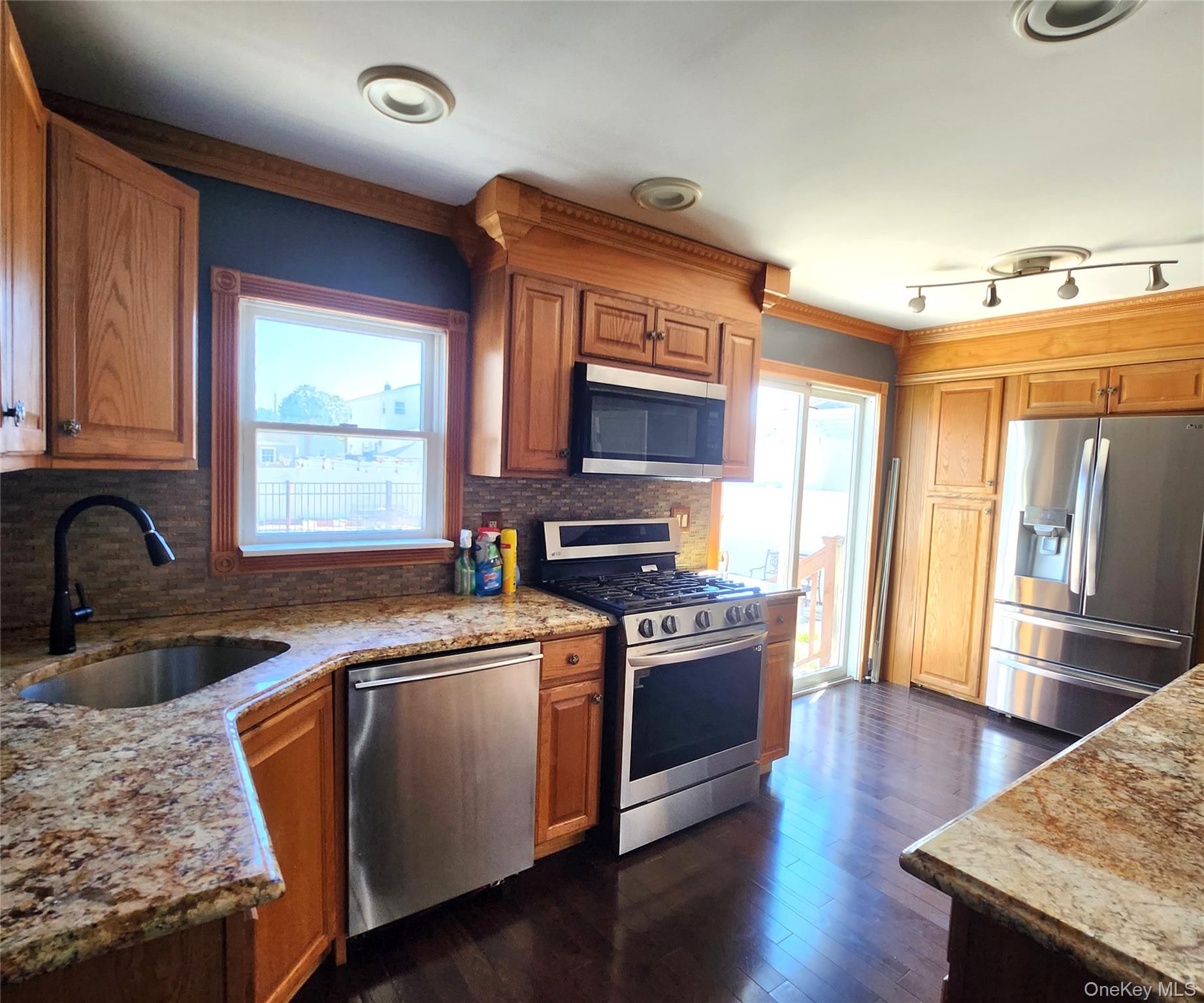 Undisclosed Address West Babylon, NY 11704 - Photo 6 of 12 a kitchen with stainless steel appliances granite countertop a sink stove and refrigerator