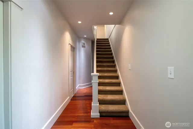 a view of entryway and hall with wooden floor