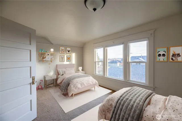 a bedroom with a bed and large window