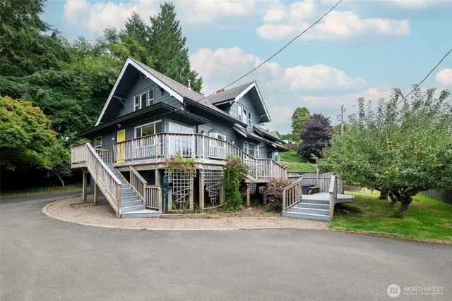 a view of house with outdoor space and sitting area