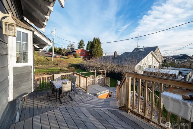a view of balcony with chairs and wooden fence