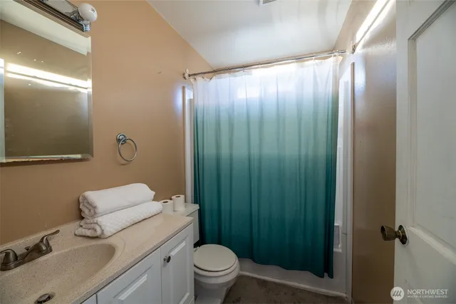 a bathroom with a toilet a sink and shower