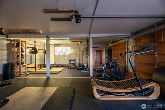 a room with gym equipment and mirror