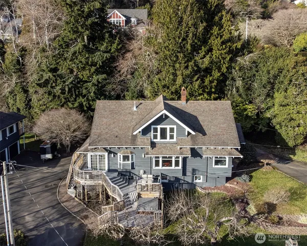 an aerial view of a house with a yard