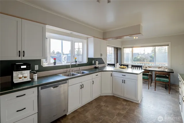 a kitchen with a sink cabinets and window