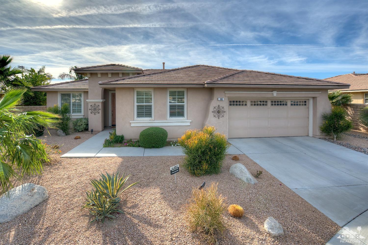 a front view of a house with a yard and a garage